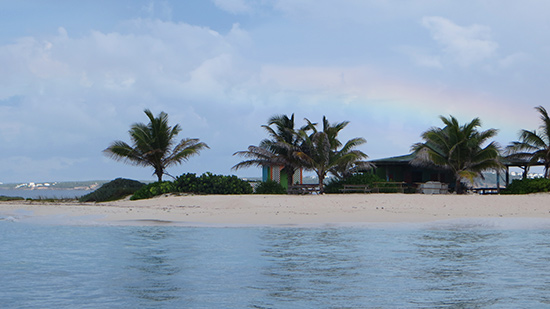 rainbow over sandy island